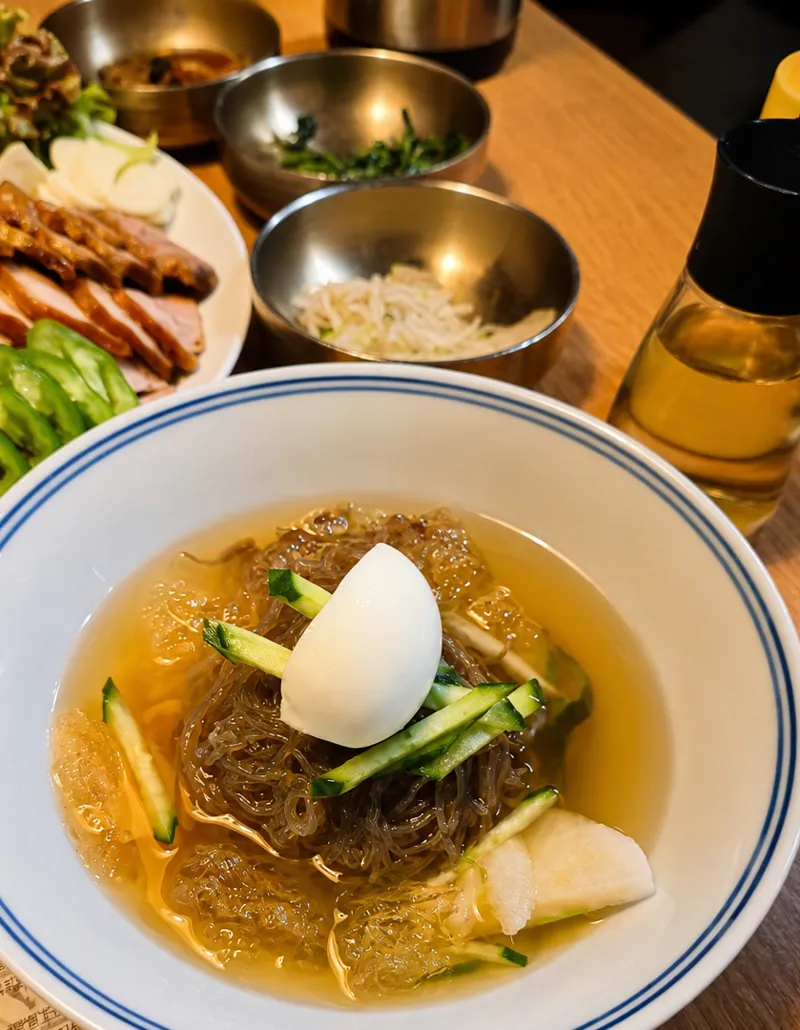 Naengmyun: cold buckwheat noodles in chilled broth with cucumber, pear and boiled egg
