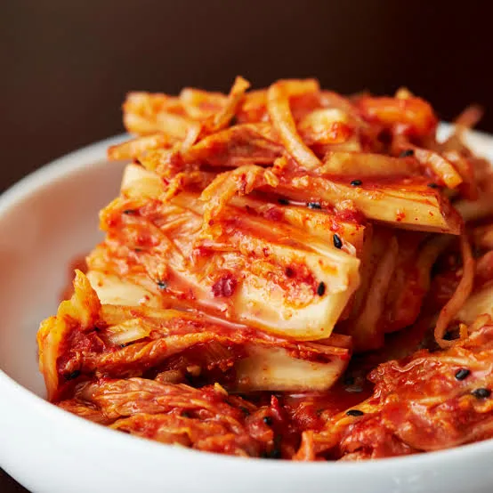 Napa cabbage kimchi in a white bowl